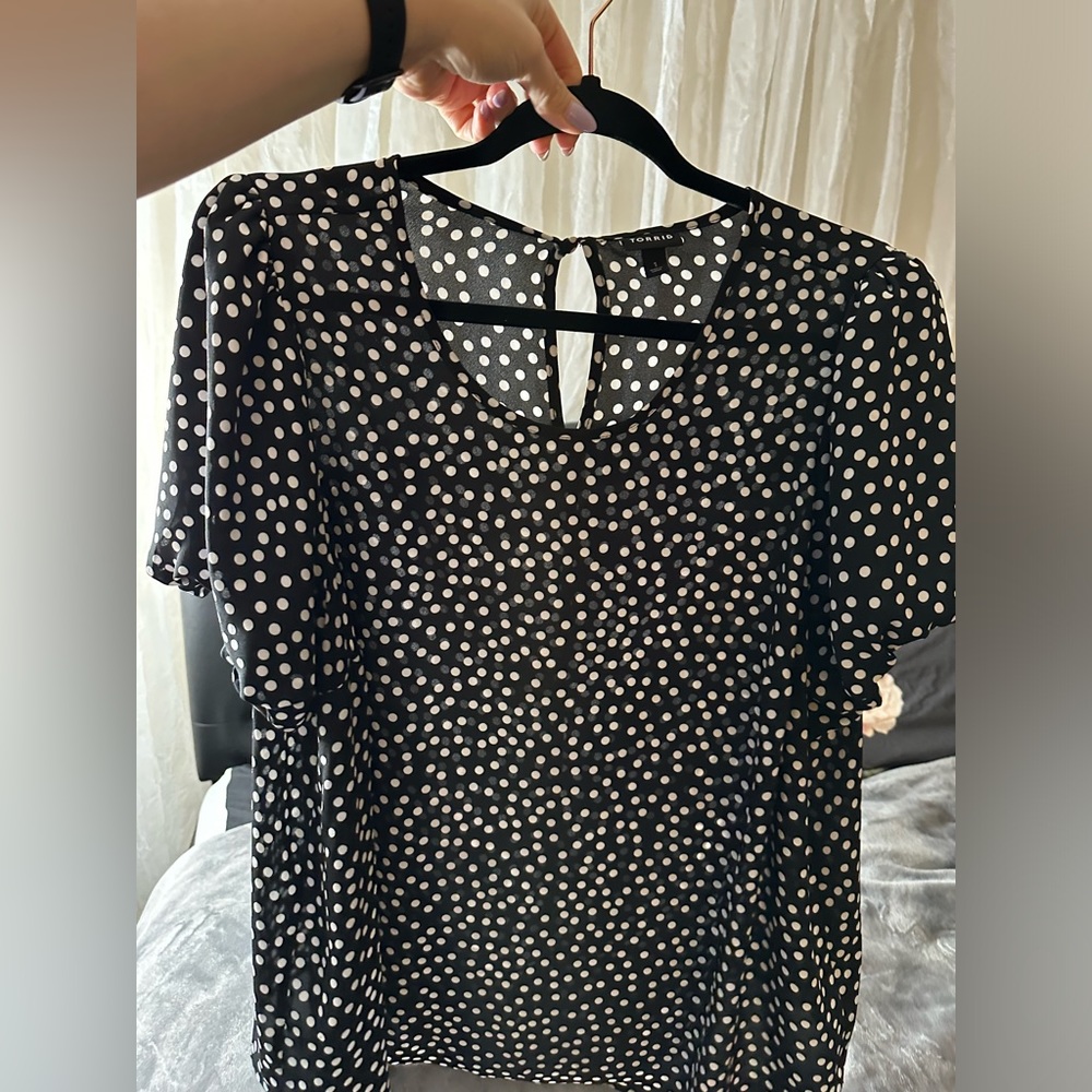 Black chiffon top with white polkadots and balloon types sleeves.